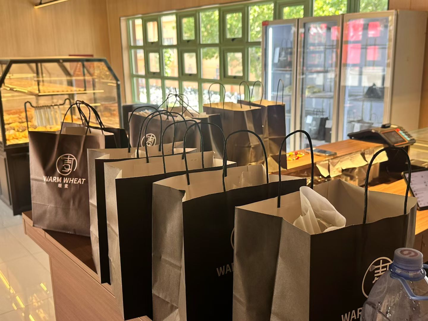 Warm Wheat branded takeaway bags inside the bakery.
