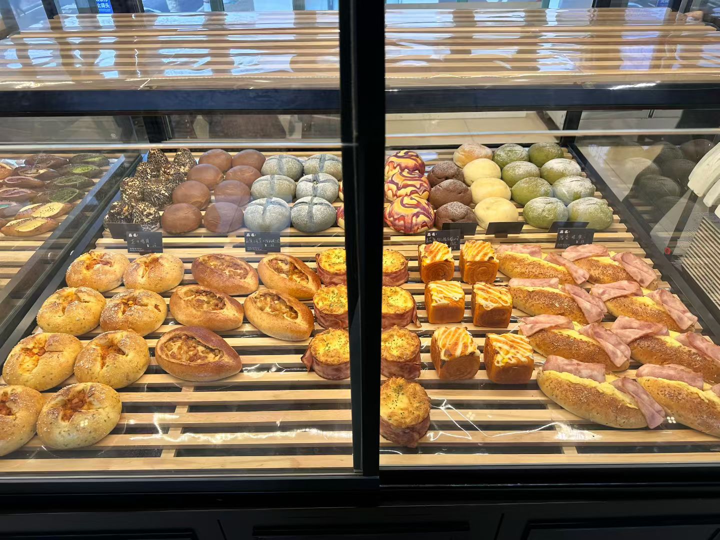 Warm Wheat display case filled with fresh breads and savory baked goods.