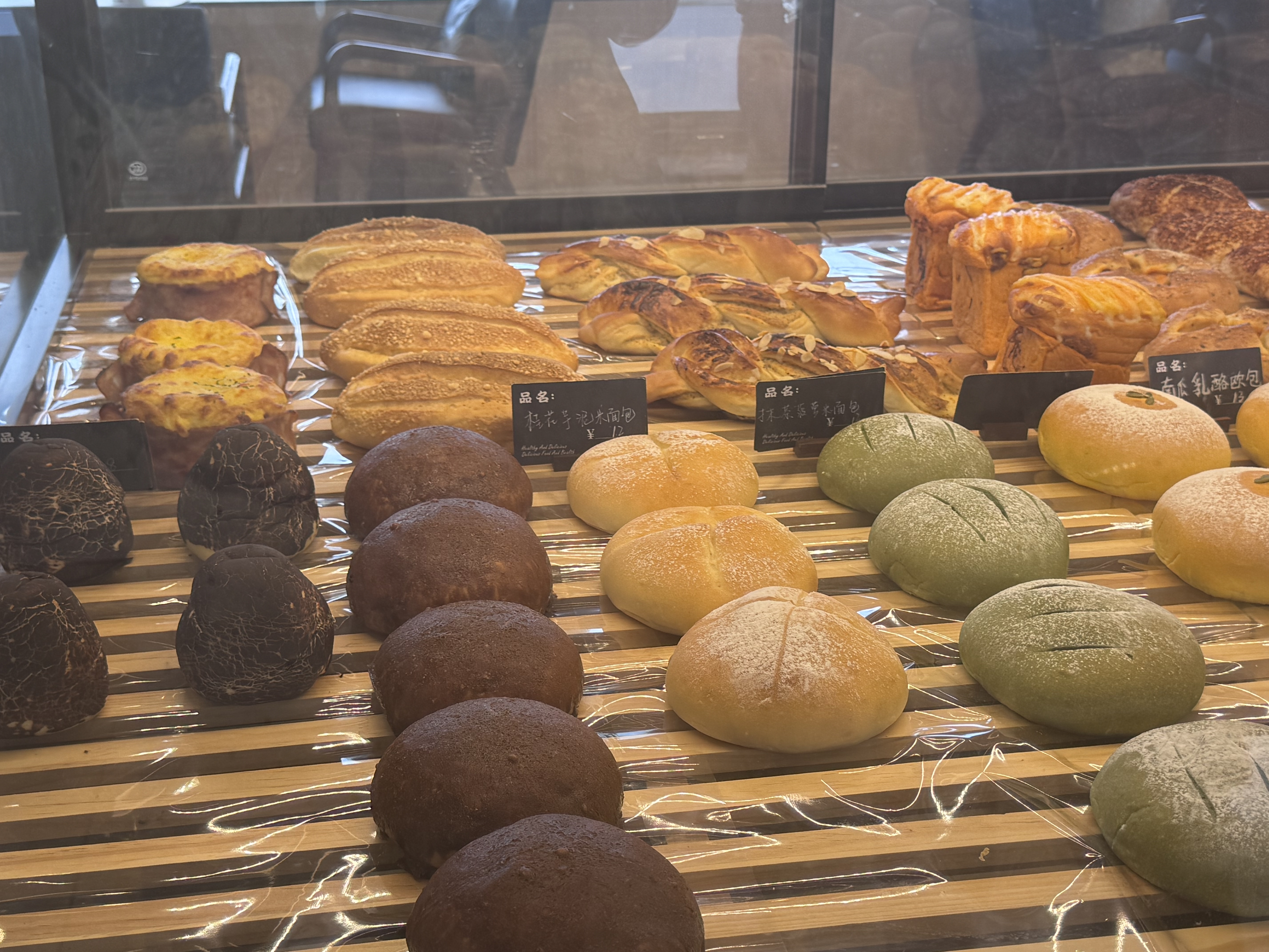 Close-up of Warm Wheat breads including rice breads, savory breads, and soft buns.