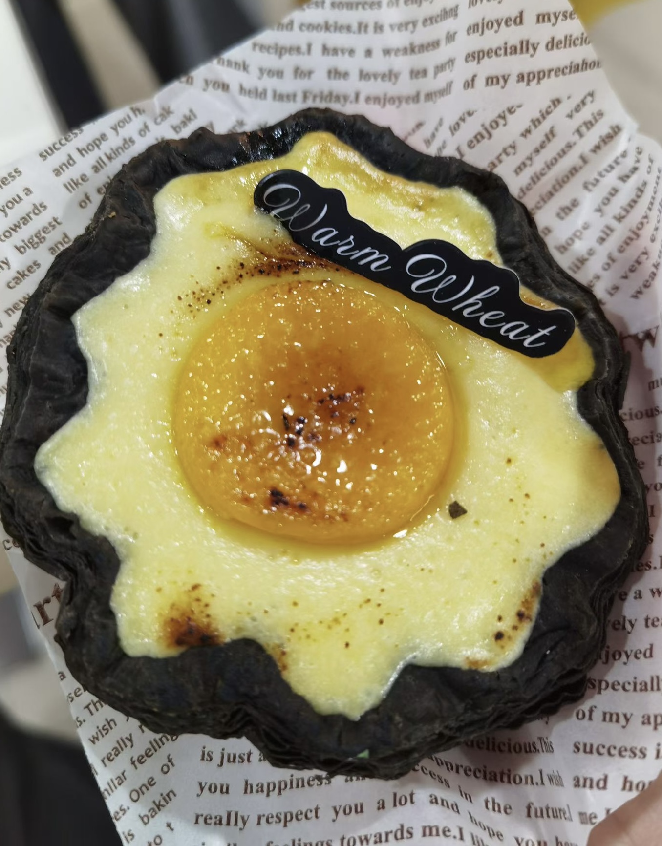 Lemon egg tart with glossy custard and a citrus center.